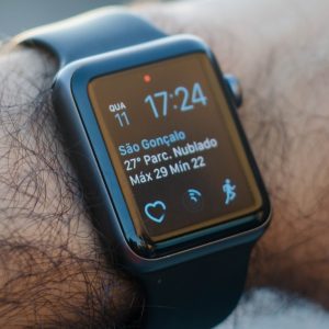 Smartwatch on a wrist displaying weather information and time.