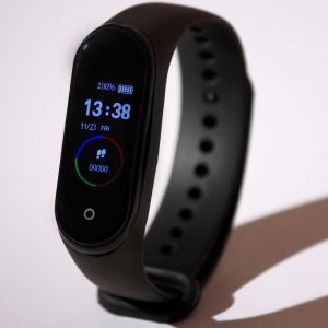 Black smartwatch with digital display on a white background