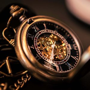 Close-up of a vintage pocket watch with intricate mechanical details.