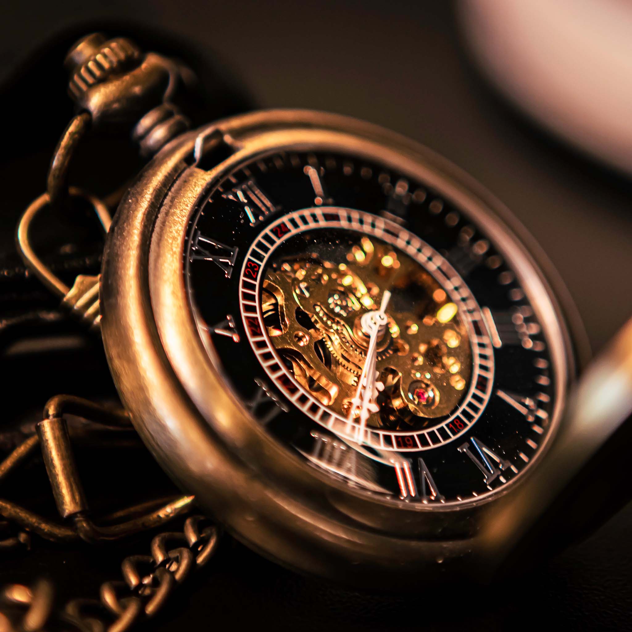 Close-up of a vintage pocket watch with intricate mechanical details.
