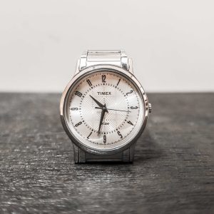 Timex watch on a textured surface with a neutral background