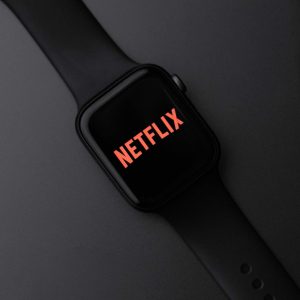 Smartwatch with Netflix logo on a dark background