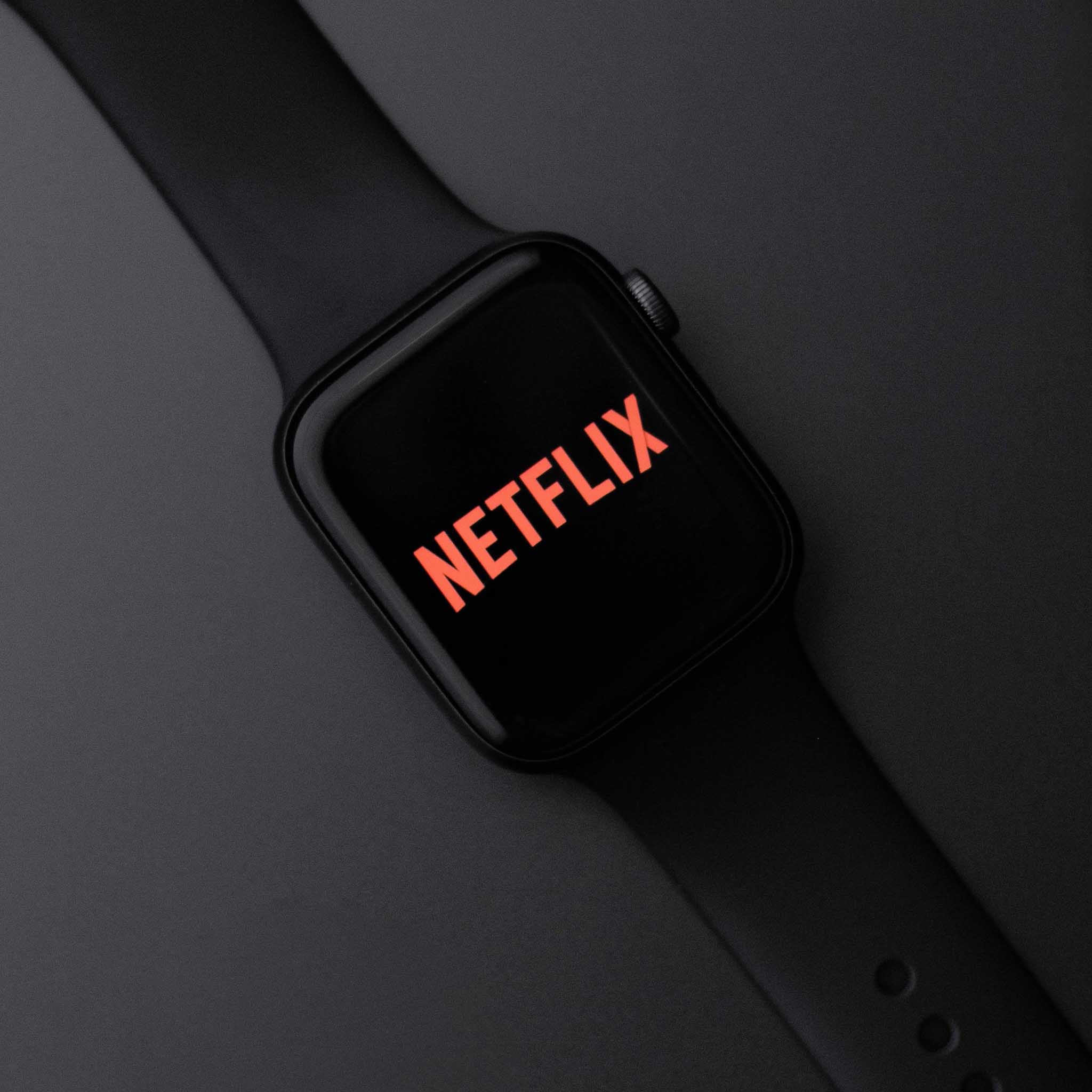 Smartwatch with Netflix logo on a dark background